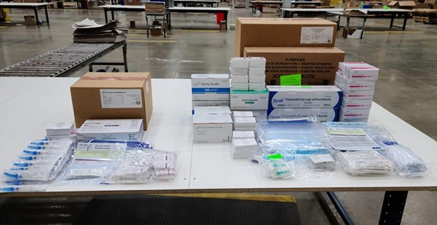 Ancillary supplies and mixing kits on a table in the SNS warehouse